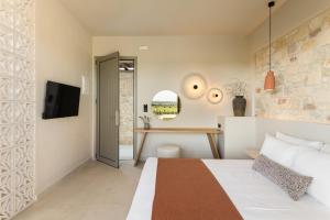 a hotel room with a bed and a desk at TERTH - Afytos Experience in Afitos