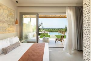 a bedroom with a bed and a sliding glass door at TERTH - Afytos Experience in Afitos +56 photos