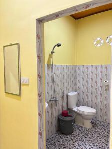 a bathroom with a toilet and a shower at Toba Boi in Tuktuk Siadong