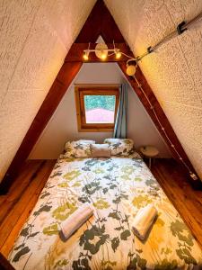 a bedroom with a bed in a attic at Jó, hogy itt vagy! in Orfű
