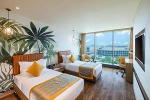 a hotel room with two beds and a large window at Plume Hotels, India Expo Mart, Greater Noida in Greater Noida