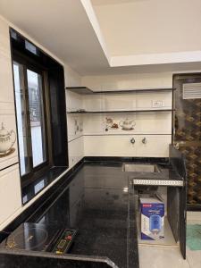 a kitchen with a counter with a box in it at KD Homes - Elite studio stay in Surat