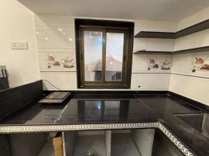 a empty room with a window and a table at KD Homes - Elite studio stay in Surat