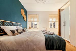 a bedroom with a large bed with a blue wall at Ma Bégude in Rieutord