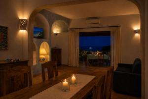 a living room with a table with candles on it at Big Pevero Sea View House 7 Two Bedrooms in Porto Cervo +9 photos
