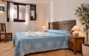 a bedroom with a bed with two towels on it at Big Pevero Sea View House 7 Two Bedrooms in Porto Cervo