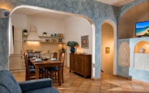a kitchen and living room with a table and chairs at Big Pevero Sea View House 7 Two Bedrooms in Porto Cervo