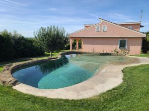 a swimming pool in front of a house at Finca SOTOMAR-casa rural Simancas in Simancas