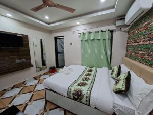 a bedroom with a bed and a ceiling fan at Hotel Dev Inn in Dhangadhi +34 photos