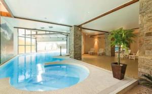 a large swimming pool in a large building at Cauterets Mountain Nest in Cauterets
