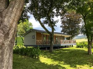 a house with a large deck in a yard at Moulin de Hotton in Hotton +13 photos