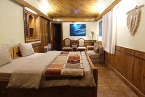 a bedroom with a large bed in a room at Shantiniketan Mountain Home in Almora