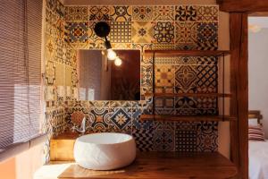 a bathroom with a sink and a mirror at Ma Bégude in Rieutord +17 photos