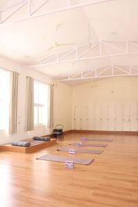 a room with yoga mats on the floor in a room at Aarunya Stays in Rishīkesh