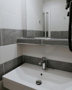 a bathroom with a sink and a mirror at ŠD Jedlíkova 9 in Košice +11 photos