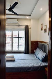 a bedroom with a large bed with a window at Aarunya Stays in Rishīkesh +13 photos