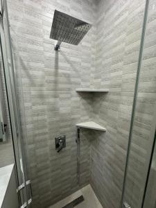 a bathroom with a shower with a glass door at Miri Apartments in Ulcinj +16 photos
