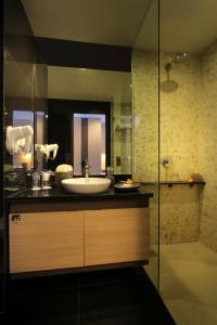 a bathroom with a sink and a shower at b Hotel Bali & Spa in Denpasar