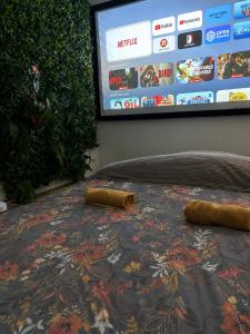 a table with two bottles on it with a tv screen at La Cave Des Merveilles in Mâcon