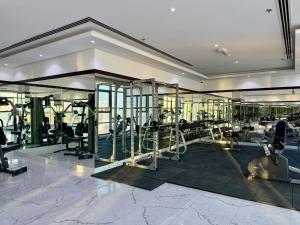 a gym with treadmills and ellipticals in a building at Al Safwa One in Al Ḩadd