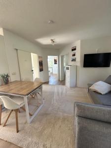 a living room with a table and a couch at Ferienwohnung Am Weifberg in Hinterhermsdorf Sächsische Schweiz in Hinterhermsdorf