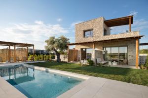 a house with a swimming pool in the backyard at TERTH - Afytos Experience in Afitos