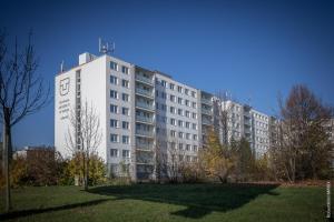 a white building with a sign on the side of it at ŠD Jedlíkova 9 in Košice