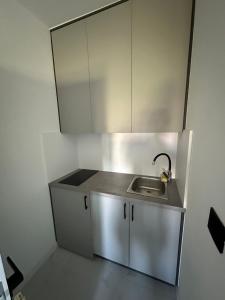a small kitchen with a sink and a mirror at Miri Apartments in Ulcinj
