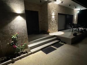 a lobby with stairs and a table and chairs at Miri Apartments in Ulcinj