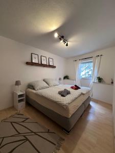 a bedroom with a bed and a window at Ferienwohnung Moselblick in Alf