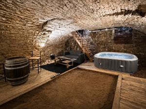 a room with a bath tub in a stone cave at La Cave Des Merveilles in Mâcon