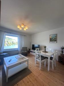 a living room with a table and a table and chairs at Ferienwohnung Moselblick in Alf