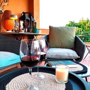 two glasses of wine sitting on a table at La Masia Costa Brava -Adults Only in Garrigás +19 photos