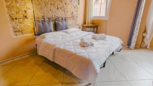 a bedroom with a large bed with towels on it at Domus Dantis - Italian Homing in Ravenna