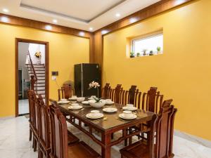a dining room with a table and chairs at Villa FLC Sầm Sơn SH20 in Sầm Sơn
