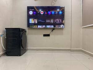 a room with a tv on a wall next to aether at KD Homes in Surat