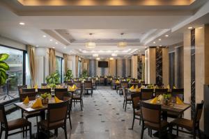 a banquet hall with tables and chairs and a podium at Hotel Sarmis in Deva