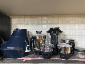 a kitchen counter with a blender and other appliances at KD Homes in Surat +39 photos