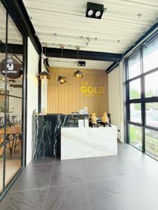 a lobby with a gold sign on the wall at The Gold Living Life in Thung Song +36 photos