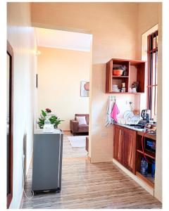 a kitchen with a refrigerator in the middle of a room at Winnie's Home in Morogoro