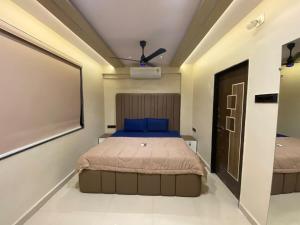 a bedroom with a bed and a projector at KD Homes in Surat