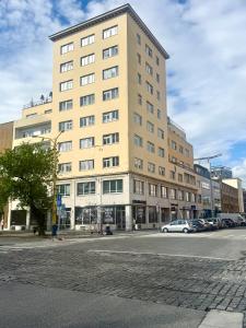 a tall building on a city street with a car at Alexander library apartment in Košice