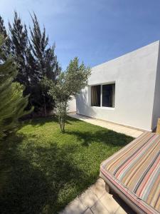 a backyard with a couch in the grass at Villa TerraVerde in Al Ghar