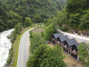 a road next to a river next to a building at AYDER VANAK SUİTEs in Ayder Yaylasi