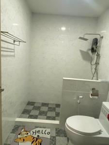 a bathroom with a toilet and a phone on the wall at The sun homestay01 in Ko Kood