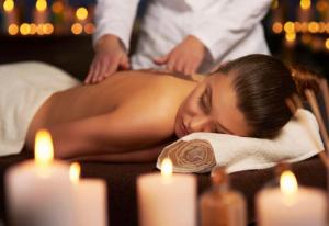 a woman laying on a towel getting a massage at GG Landlords Room & Spa in Vasto +16 photos