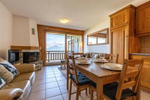a dining room with a table and a couch at Plein Ciel VA 022 - MOUNTAIN apartment 4 pers in Veysonnaz
