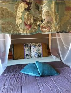 a bed with two blue pillows on top of it at Jetset Parisian Holiday Home in Cesson +90 photos