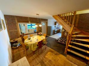 a dining room and kitchen with a table and a staircase at Ferienwohnung Scheffler in Krakvitz