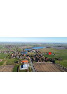 an aerial view of a village and a river at Apartment in Stedesdorf